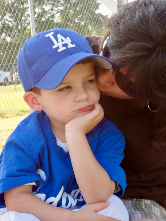 Baseball Boy Being Kissed  by Charles Van Deursen