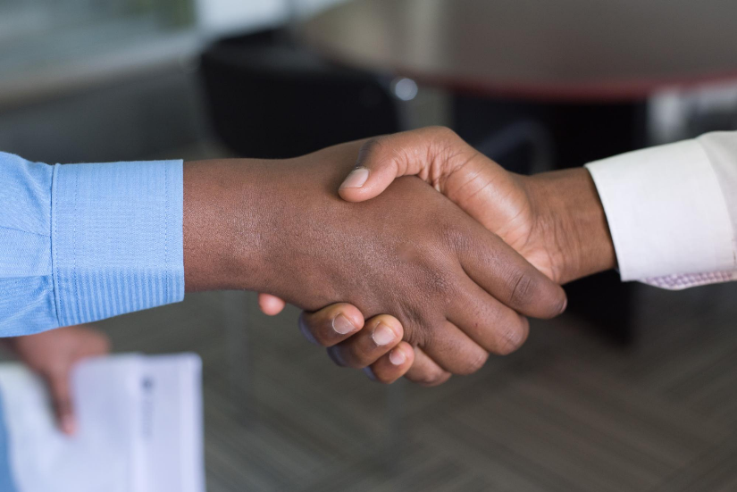 Two People Shaking Hands Photo by Cytonn Photography on Unsplash