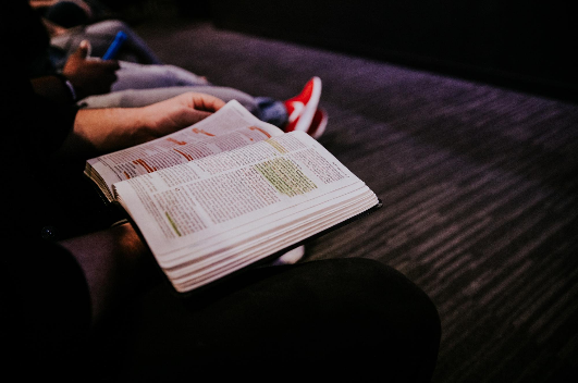 "Person Reading Book" by Hannah Busing on Unsplash