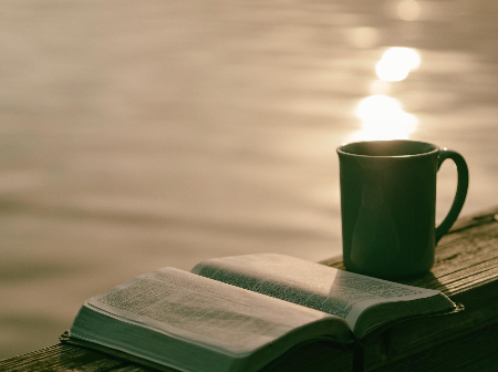 "Green Ceramic Mug Beside Book" by Aaron Burden on Unsplash