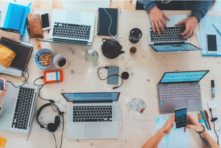 "people sitting down at table with assorted laptop computers" by  Marvin Meyer